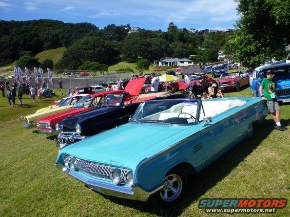 Light blue 1961 Mercury convertible parked on grass at car show