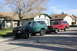 1991 Ford Bronco - Two Ford Broncos, one green and one red, are parked on a residential street.