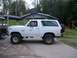 1985 Ford Bronco - Side view of a white 1985 Ford Bronco parked outdoors.