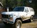 1985 Ford Bronco - This muddy 1985 Ford Bronco is shown from a 3/4 front angle.