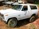 1985 Ford Bronco - White 1985 Ford Bronco with custom exhaust pipes visible on the hood.