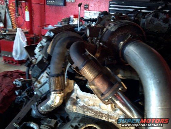 Close-up of a turbocharger and exhaust manifold with large diameter pipes