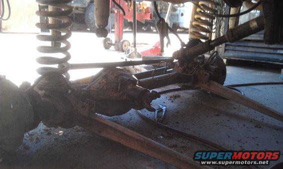 Undercarriage view of vehicle suspension and axle components