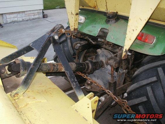 Tractor rear hitch with yellow and green body panels