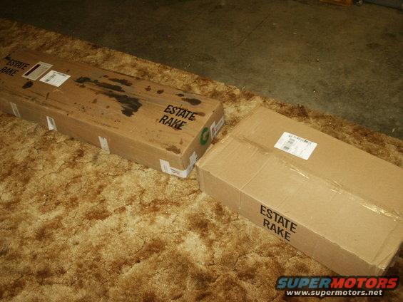 Two "ESTATE RAKE" boxes on a carpeted floor