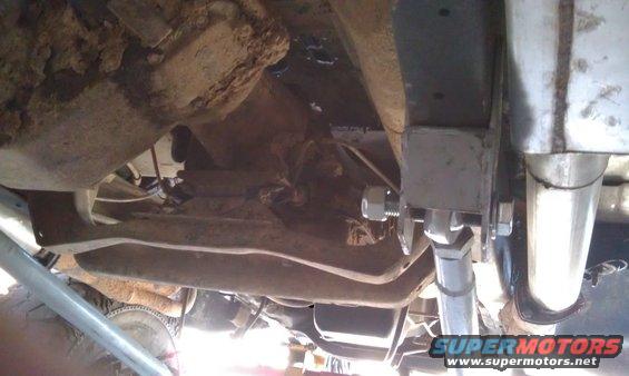 Undercarriage view showing suspension components and exhaust pipe