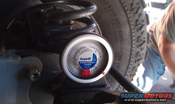 Magnetic protractor on vehicle suspension near tire