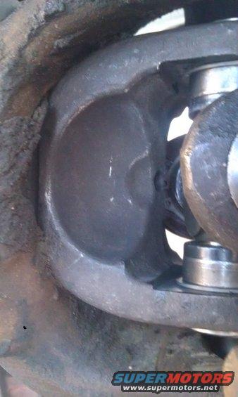 Close-up of a driveshaft universal joint with grease and dirt