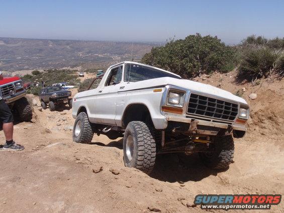 White 1978 Ford Bronco on a rocky trail, front 3/4 view