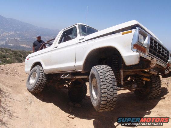 White 1978 Ford Bronco on a dirt trail, front 3/4 view