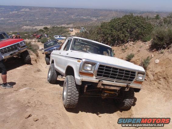 White 1978 Ford Bronco on a rocky trail, front 3/4 view