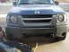 2004 Nissan Xterra - A mechanic works on the underside of a dark blue 2004 Nissan Xterra, captured from a front-facing perspective.