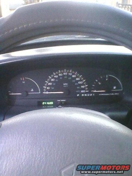 Dashboard with speedometer, odometer showing 241169 miles, and fuel gauge. Steering wheel is visible