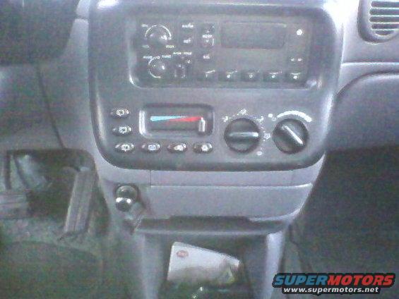 Car dashboard with radio, climate controls, and cigarette lighter