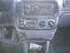 1997 Plymouth Voyager - Interior view of a car's dashboard, showing the central console with various controls and a storage compartment.