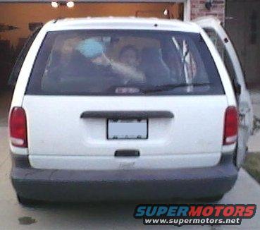 White minivan rear view with open passenger door