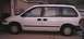 1997 Plymouth Voyager - Side view of a white 1997 Plymouth Voyager minivan.