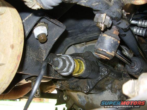 As soon as the threads were exposed, I could see there was a problem - the bright yellow oil from the actuator had leaked out.