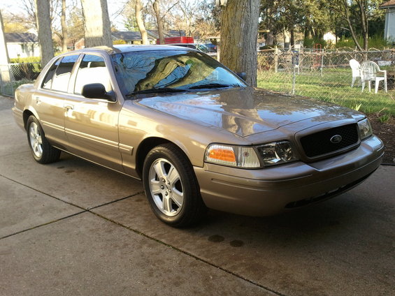 Tan 2007 Ford Crown Victoria parked on a concrete driveway