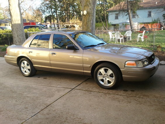 Tan 2007 Ford Crown Victoria parked on a driveway