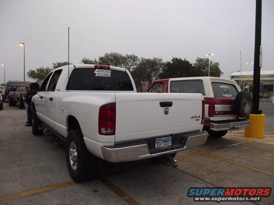 Red and white SUV rear view with spare tire mounted on the back