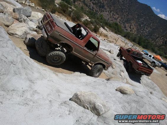 1978 Ford Bronco on rocks, 3q-front view, red