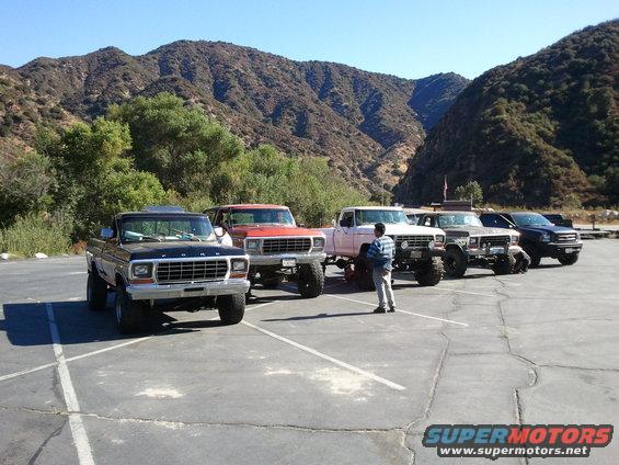 Black 1978 Ford Bronco parked in a lot with other trucks, front view
