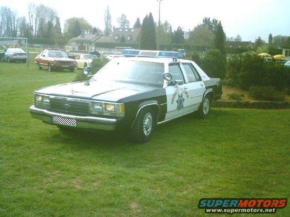 Black and white police car with light bar, 1991 Ford Crown Victoria