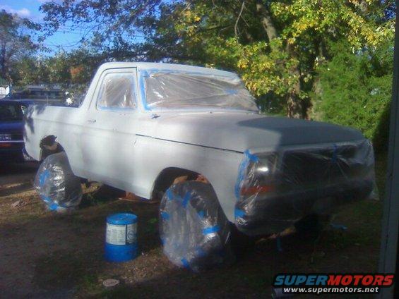 1979 Ford Bronco in primer, covered in plastic for painting