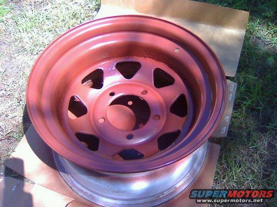 Red painted steel wheel with triangular cutouts