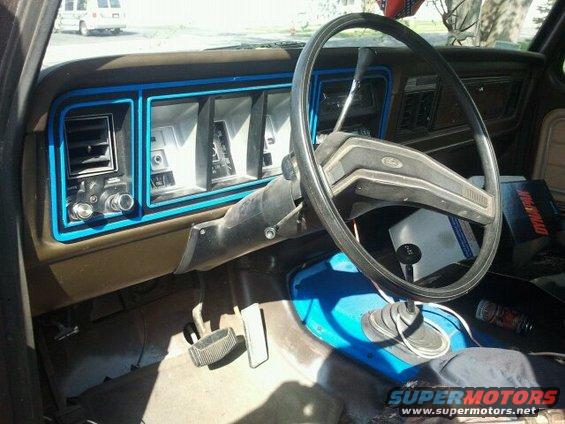 Interior shot of a 1979 Ford Bronco showing dashboard, steering wheel, and gear shifter