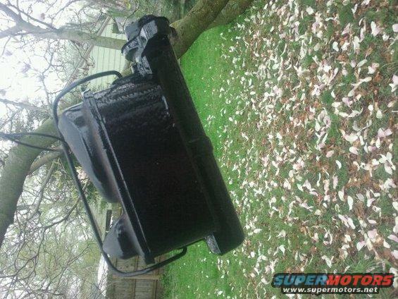 Black painted part with metal frame, outdoors