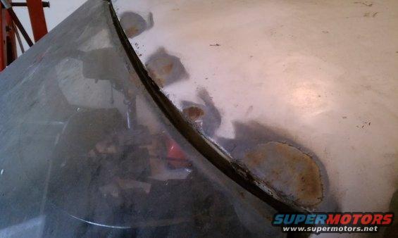 Few small surface rust patches along the windshield on the driver side.  