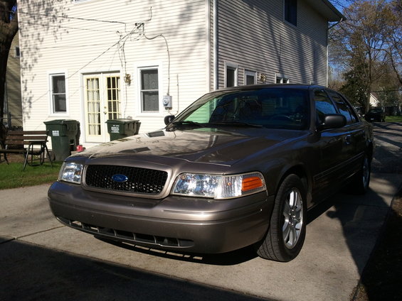 Brown 2007 Ford Crown Victoria parked on driveway, front 3/4 view