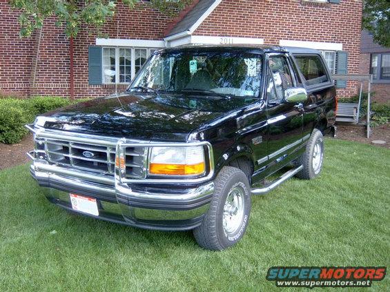 Black Ford Bronco with chrome grille and bumper, parked on grass