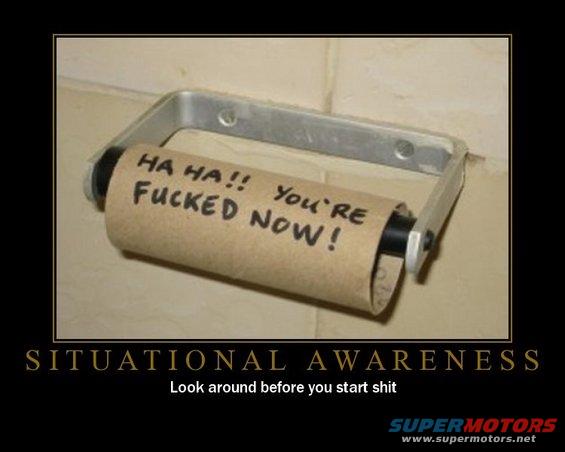 Empty toilet paper roll on holder, with text 'HA HA!! YOU'RE FUCKED NOW!' written on the cardboard tube