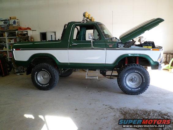 1979 Ford Bronco, green and white two-tone paint, lifted suspension, hood open