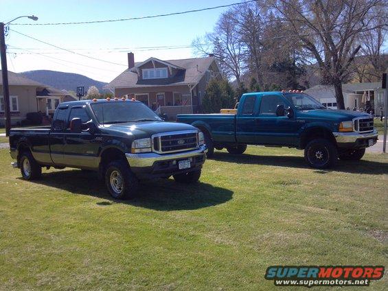 Two Ford Super Duty trucks parked on a lawn