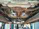 2004 Mercury Grand Marquis - The underside of a vehicle is shown, a dual exhaust system and fuel tank, raised on a lift.