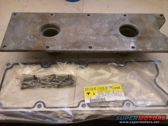 Engine valve cover and gasket with part numbers visible