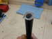 2005 Honda CR125R - A close-up view shows the end of a black hose with braided reinforcement, resting on a workbench.