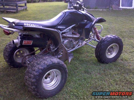 Black 2005 Honda TRX 450 R ATV with aftermarket exhaust, viewed from the rear three-quarter angle