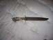 1993 Ford Bronco - A hunting knife with a textured blade and a handle made of bone or antler is shown.