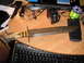 1993 Ford Bronco - A large, rusty knife with an antler handle is placed on a desk with various items.