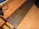 1993 Ford Bronco - A close-up view of a knife with a rusty blade and a wooden handle.