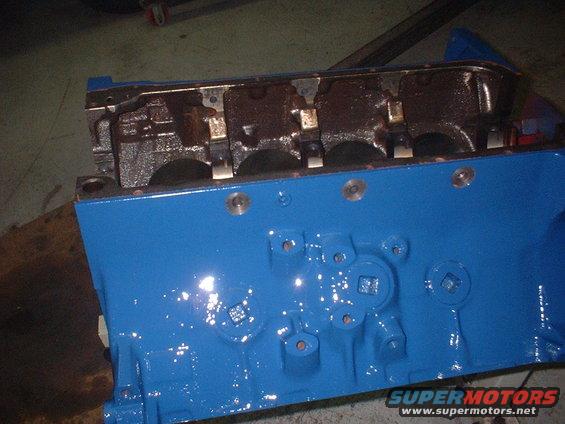 Blue painted engine block with visible internal components and bolt holes