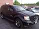 2007 Dodge Durango - A black SUV is parked in a lot, showing its front and side profile with other vehicles nearby.