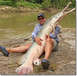 1993 Ford Bronco - A man proudly displays a massive alligator gar he caught near a river.