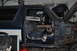1986 Ford Bronco - The interior of a blue SUV is visible with the driver's side door open, revealing the seats and dashboard area.