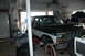 1986 Ford Bronco - A dark blue and white Ford Bronco is parked in a garage with its hood open, and another vehicle is visible in the background.